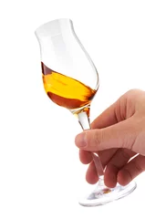 glass of brandy or whisky in the hand