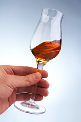 glass of brandy or whiskey in the hand