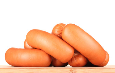 tasty sausages on wooden board isolation on white