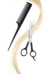 Shiny blond hair with hair cutting shears and comb isolated