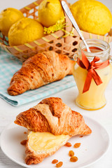 breakfast with milk lemon curd and croissant