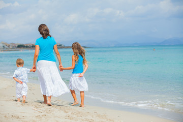 Mother and two kids having fun on beach