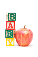 Wooden blocks and apple with baby