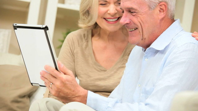 Mature Couple Enjoying Wireless Tablet Technology