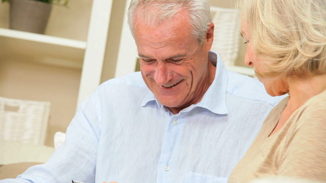 Mature Couple Enjoying Wireless Tablet Technology