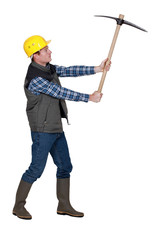 Man wielding pick-axe