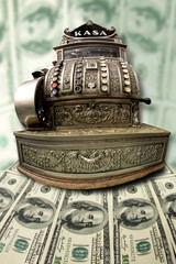 old cash register on the background of the dollars
