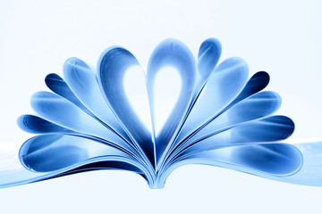 Magazine folded to heart shape isolated on white