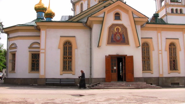 Priest coming out of a church