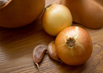 onion and garlic on a wooden table