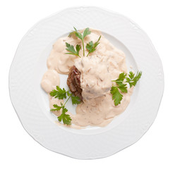 Roasted meat under white sauce