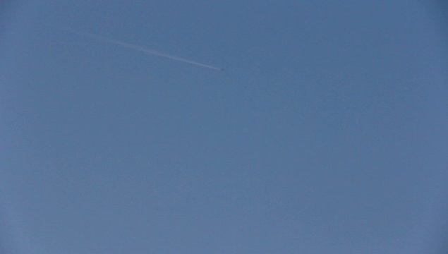 vapor trail from an airplane on blue sky.