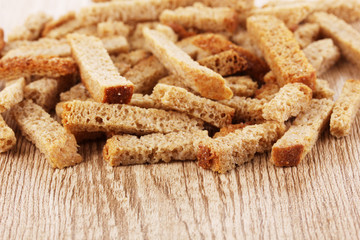 Appetizing rusks in on wooden background