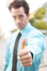 Male executive giving thumbs up