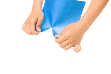 Hands Tearing Blue Paper