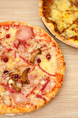 Appetizing pizza with mushrooms and ham