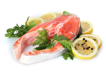 Red fish with lemon, parsley and pepper isolated on white.