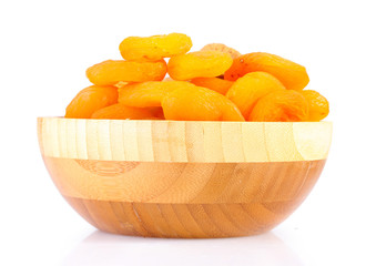 delicious dried apricots in wooden bowl isolated on white