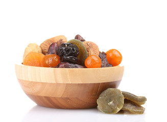 Dried fruits in wooden bowl isolated on white