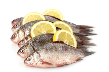 Fresh fishes with lemon isolated on white