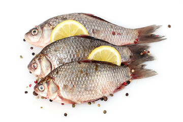 Fresh fishes with lemon and spice isolated on white