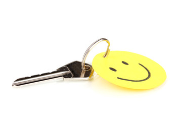 Key with smile-charm isolated on white