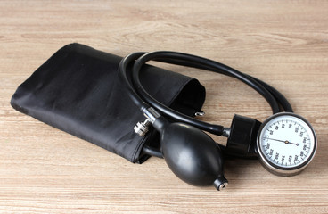 Black tonometer on wooden background