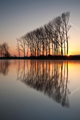 Fototapeta na wymiar Symmetry reflection on the autumn river
