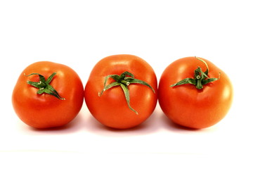 Juicy red ripe tomatoes on a white background