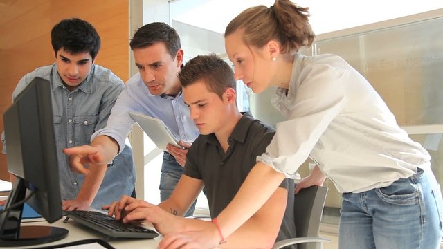 Teacher with group of students in class