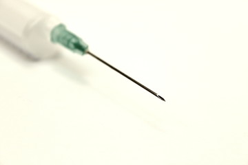 Medical needle with a syringe on a white background