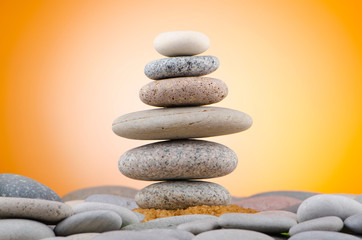 Balanced pebbles with colour background