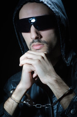 Young criminal with handcuffs
