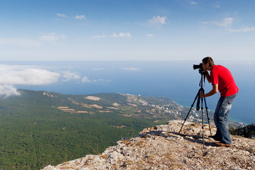 photographer with camera on mountains