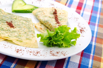 Herb stuffed pancaces in the plate