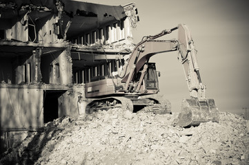 digger working during the demolition of the building