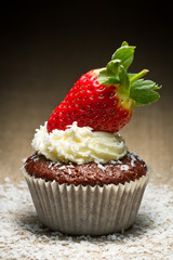 Chocolate muffin with strawberry and coconut