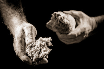 Human hand sharing with bread as charitable action