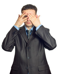 Young businessman looking through his fingers