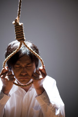 首吊り自殺を図る男性
