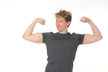 Young man flexilng his muscles