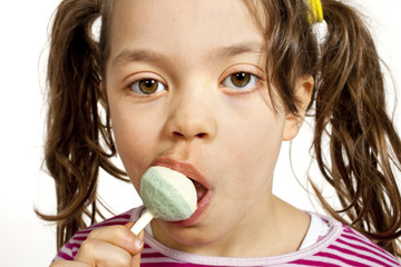 Close-up of little girl with a lollipop, on white background © alexandre zveiger