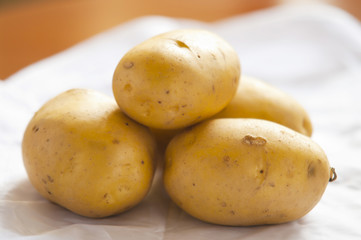 bunch of potatoes on white background close up shoot
