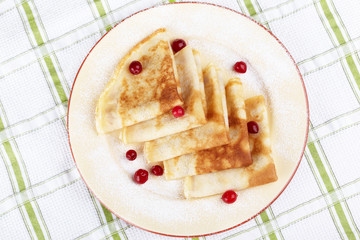 Pancakes with cranberry berries on a plate