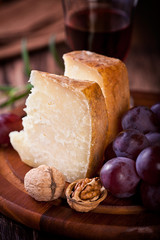 Pecorino and Red Grapes on Wooden Board