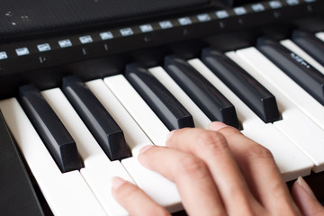 Fototapeta premium Piano keyboard with hand