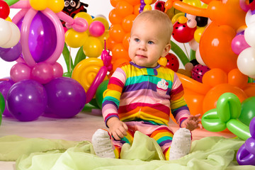 Cute baby in balloon forest
