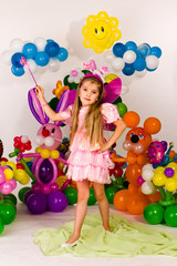Beautiful little girl in balloon forest