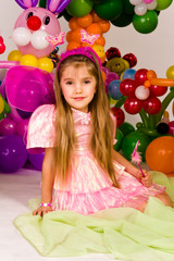 Beautiful little girl in balloon forest