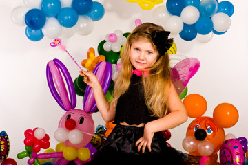 Beautiful little girl in balloon forest